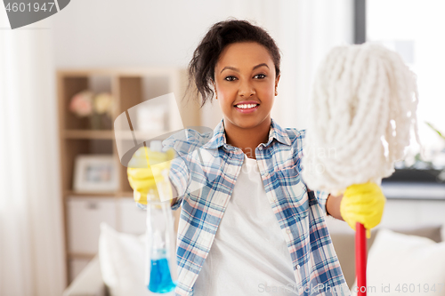 Image of african american woman with mop cleaning at home