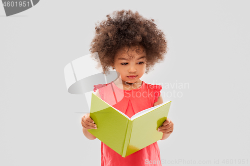 Image of sad little african american girl reading book