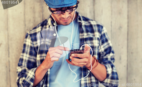 Image of man with earphones and smartphone listening music