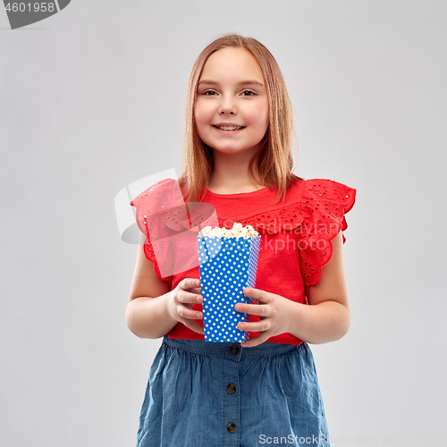 Image of beautiful smiling girl in red shirt and skirt