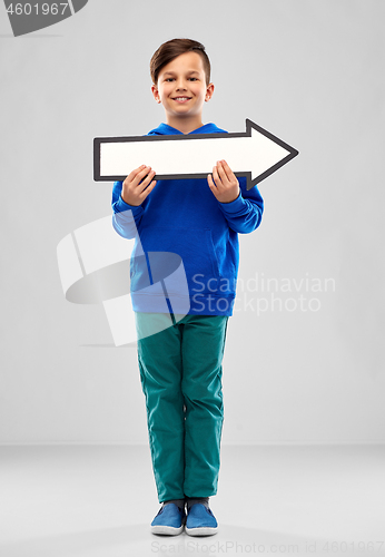 Image of boy holding big white rightwards thick arrow