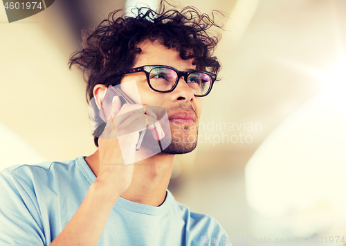 Image of man with smartphone calling on city street