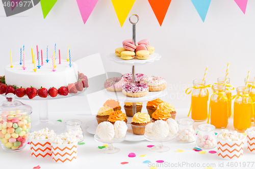 Image of food and drinks on table at birthday party