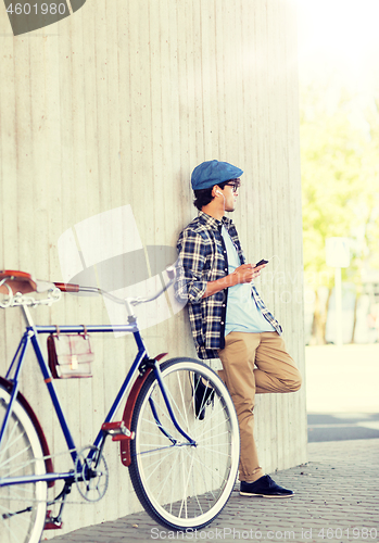 Image of man with smartphone, earphones and bicycle