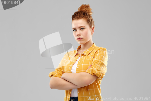 Image of serious red haired teenage girl with crossed arms