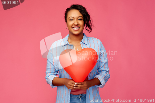 Image of african american woman with heart-shaped balloon