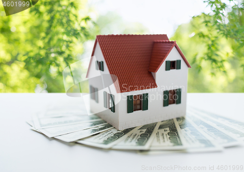 Image of close up of home or house model and money