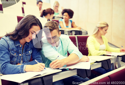 Image of group of students with notebooks at lecture hall