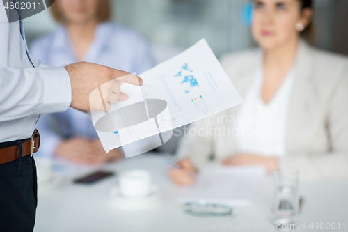 Image of close up of businessman with charts at office