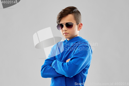 Image of portrait of boy in sunglasses with crossed arms