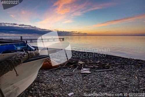 Image of Beautiful landscape with a boat by the sea at sunset