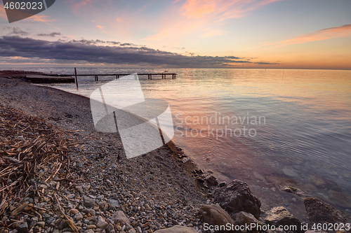 Image of Beautiful evening sunset at sea, at the far end of the pier