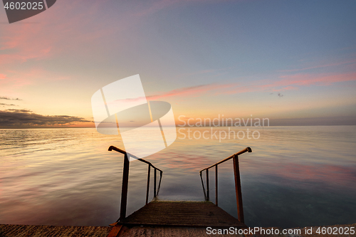 Image of Beautiful view of the evening sea, in the foreground of the stairs descendinto the sea