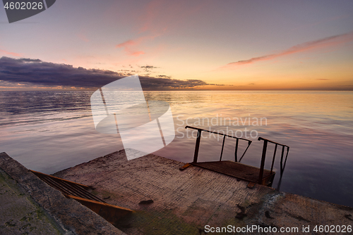 Image of Concrete sea wharf against the backdrop of a beautiful evening landscape