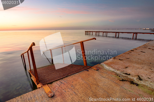 Image of Seascape, staircase descends into the sea, on the far side of the pier