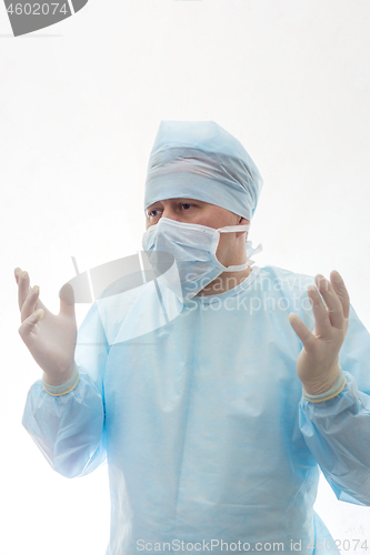 Image of Surgeon in a sterile gown, mask and gloves shrug isolated on white