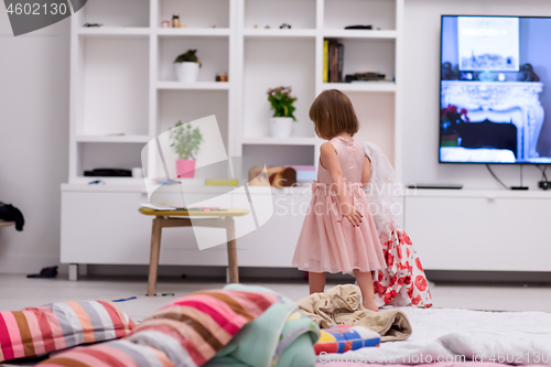 Image of mother and little daughter spending time together at home