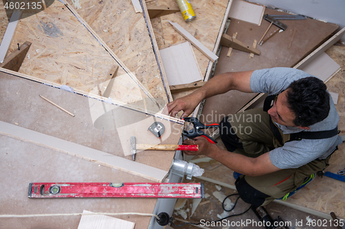 Image of carpenter installing wooden stairs