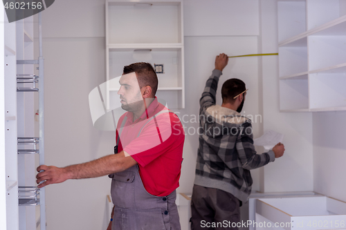 Image of workers installing a new kitchen