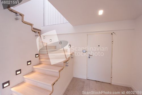 Image of stylish interior with wooden stairs