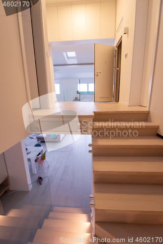 Image of stylish interior with wooden stairs