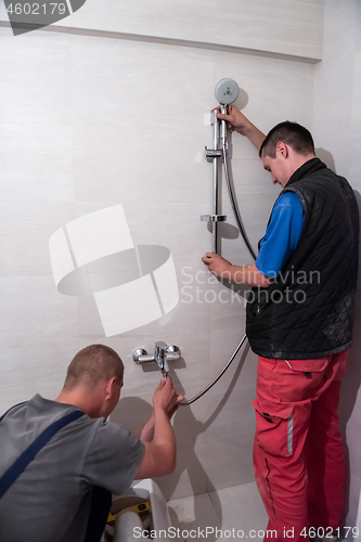 Image of professional plumbers working in a bathroom