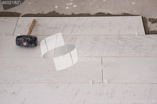 Image of Ceramic wood effect tiles and tools for tiler on the floor