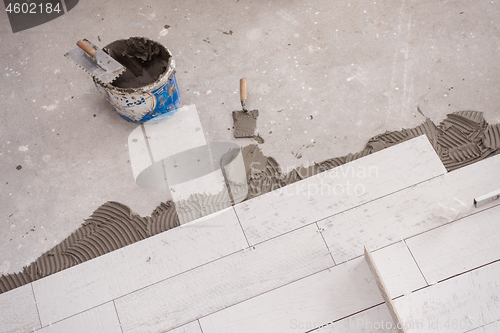 Image of Ceramic wood effect tiles and tools for tiler on the floor