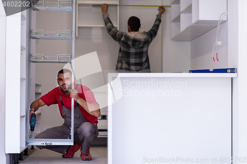 Image of workers installing a new kitchen