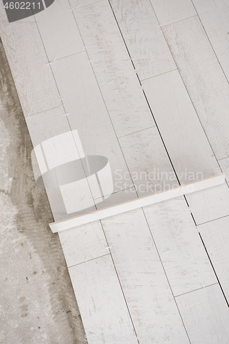 Image of Ceramic wood effect tiles and tools for tiler on the floor