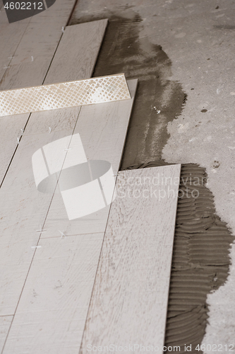 Image of Ceramic wood effect tiles and tools for tiler on the floor