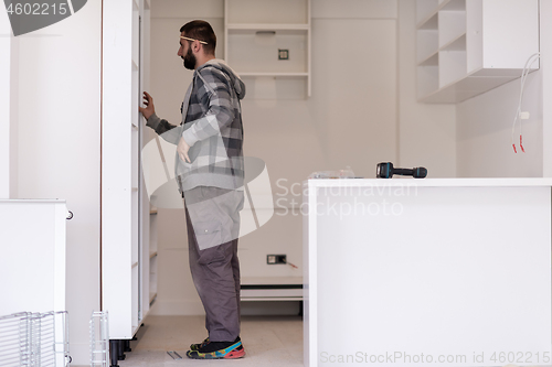 Image of worker installing a new kitchen