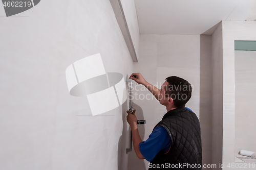 Image of professional plumber working in a bathroom