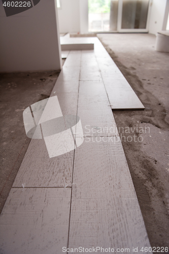 Image of Ceramic wood effect tiles and tools for tiler on the floor