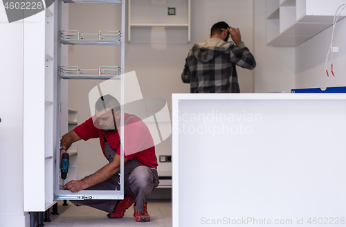 Image of workers installing a new kitchen