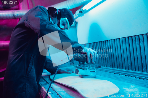 Image of Skater in process of making his own skateboard, longboard - open business concept