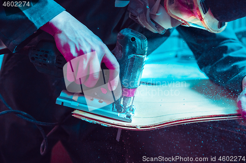 Image of Skater in process of making his own skateboard, longboard - open business concept