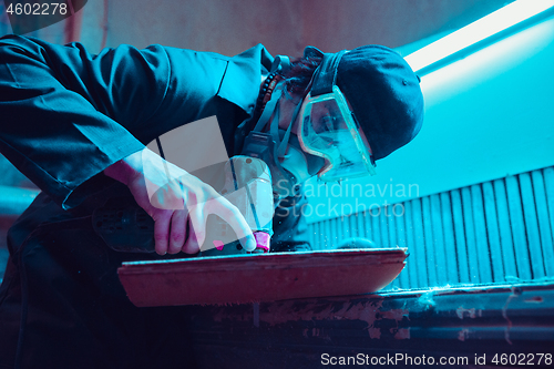 Image of Skater in process of making his own skateboard, longboard - open business concept