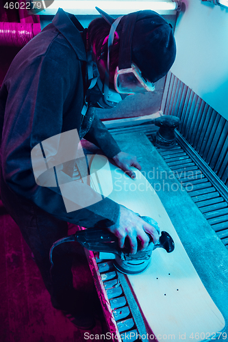 Image of Skater in process of making his own skateboard, longboard - open business concept