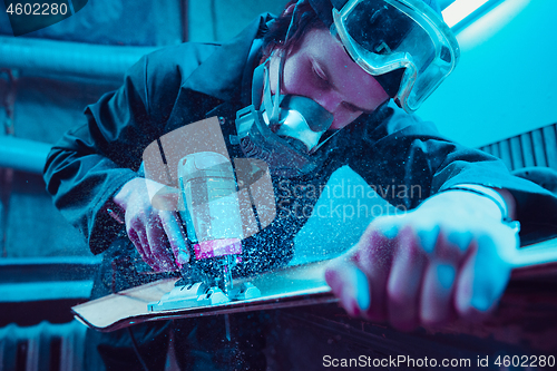 Image of Skater in process of making his own skateboard, longboard - open business concept