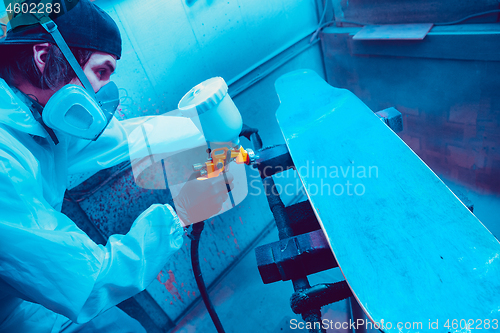 Image of Skater in process of making his own skateboard, longboard - open business concept