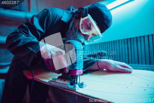 Image of Skater in process of making his own skateboard, longboard - open business concept