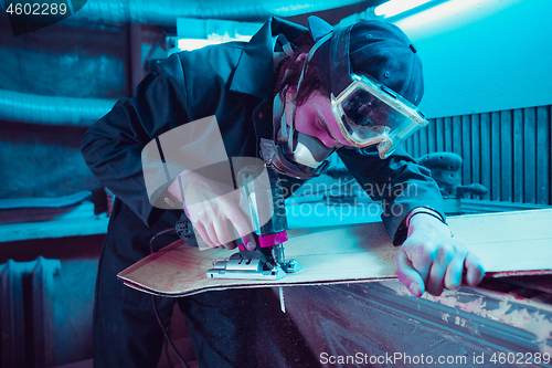 Image of Skater in process of making his own skateboard, longboard - open business concept