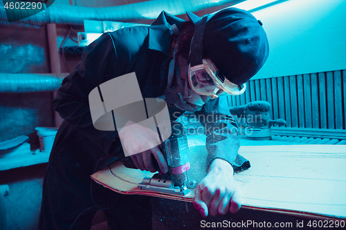 Image of Skater in process of making his own skateboard, longboard - open business concept