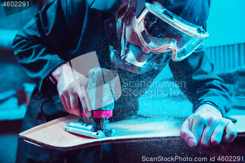 Image of Skater in process of making his own skateboard, longboard - open business concept