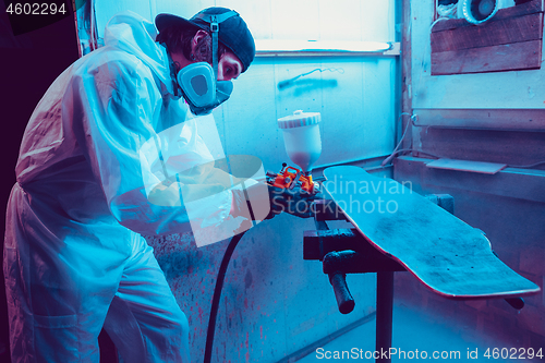 Image of Skater in process of making his own skateboard, longboard - open business concept