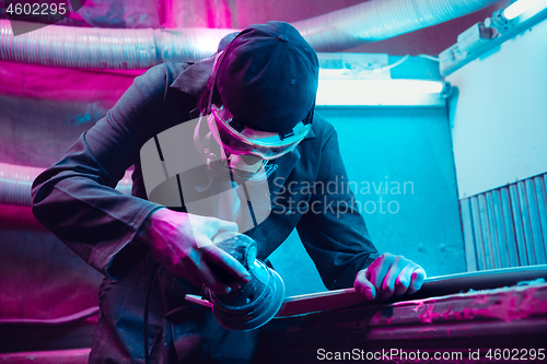 Image of Skater in process of making his own skateboard, longboard - open business concept