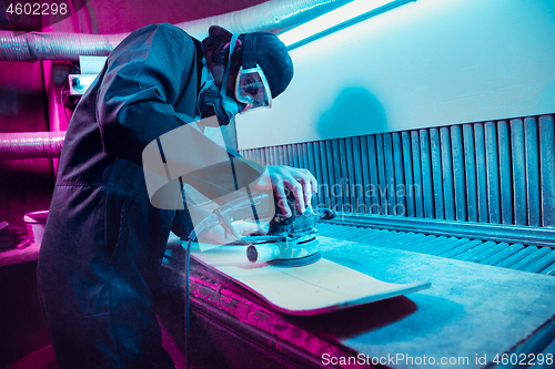 Image of Skater in process of making his own skateboard, longboard - open business concept