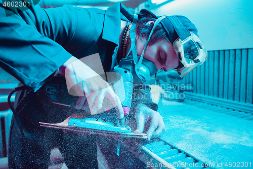 Image of Skater in process of making his own skateboard, longboard - open business concept