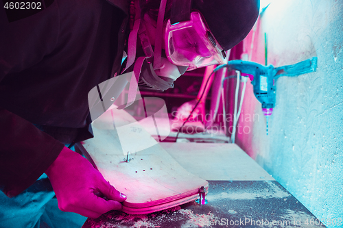 Image of Skater in process of making his own skateboard, longboard - open business concept